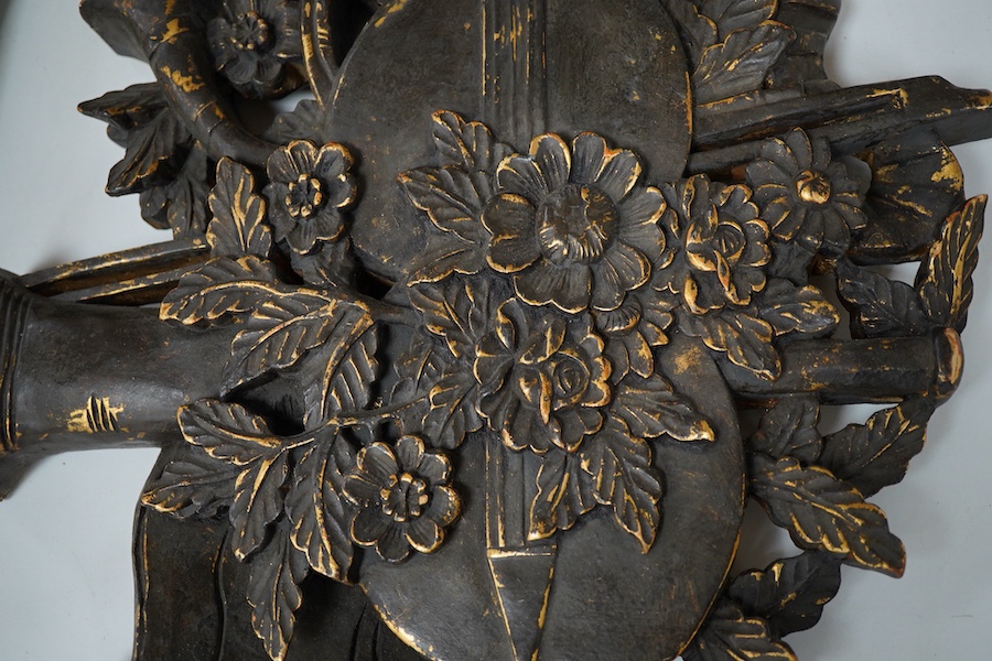 A folk art partially gilt carved panel, 50cm high